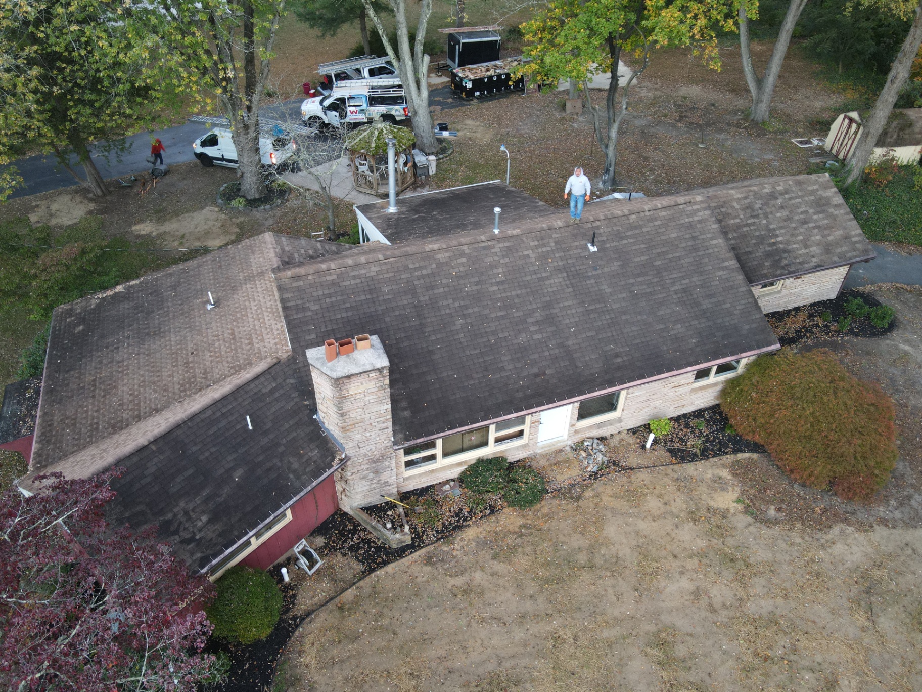 Aerial after photo of the same ranch home with a brand new gray architectural shingle roof