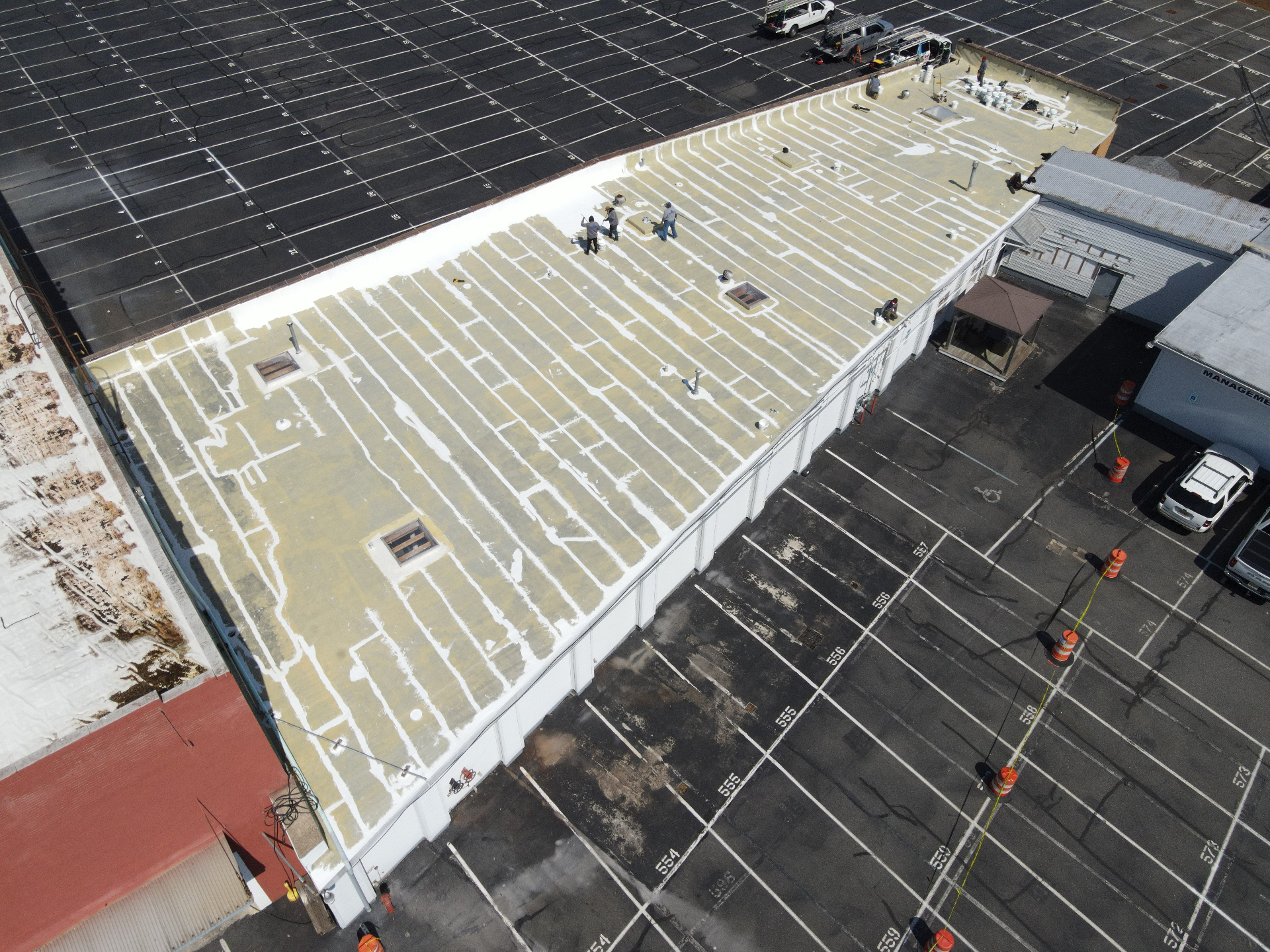 Commercial flat roof during prep work with seams and coating layout visible