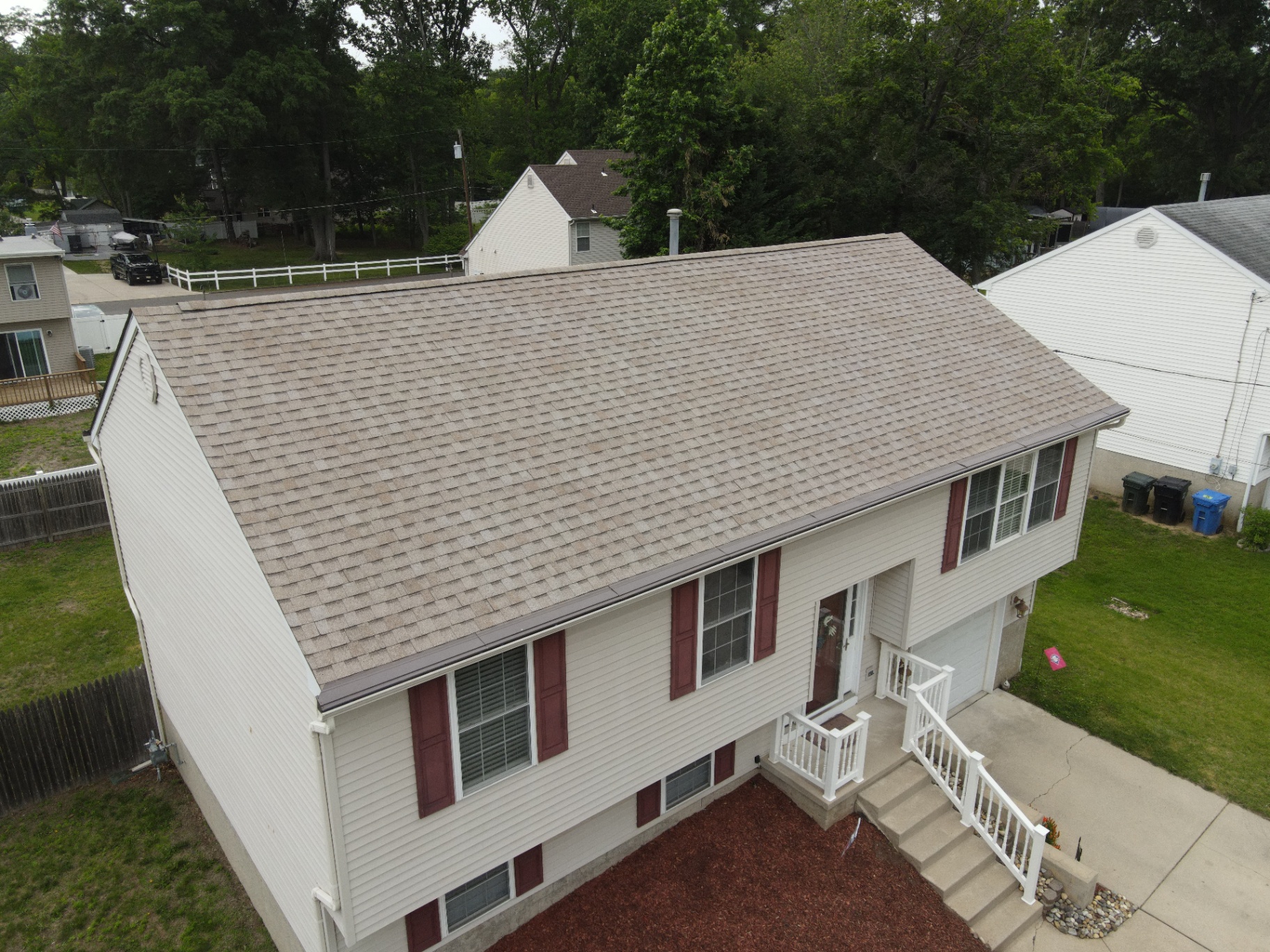 Finished tan shingle roof on a split-level home