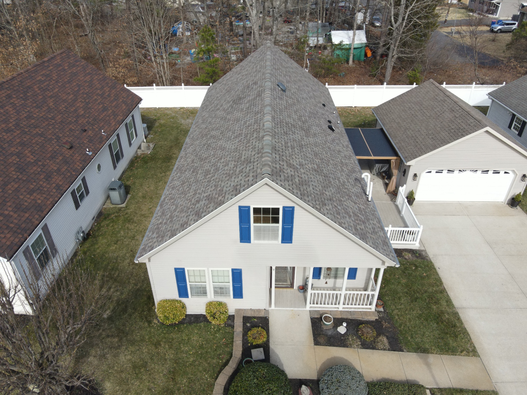 Aerial view of a steep gray shingle roof on a cape-style home