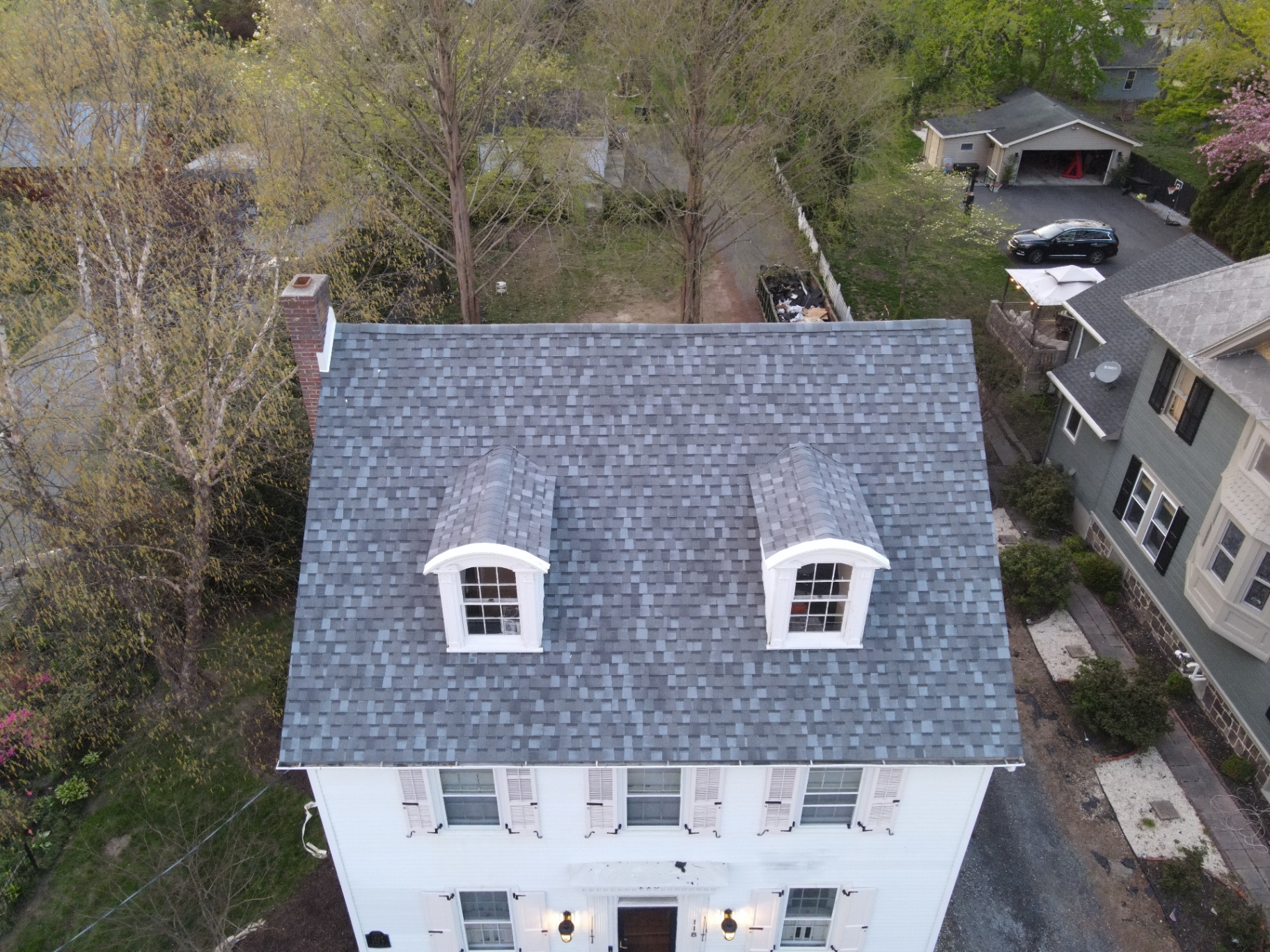Finished blue-gray residential shingle roof with dormers