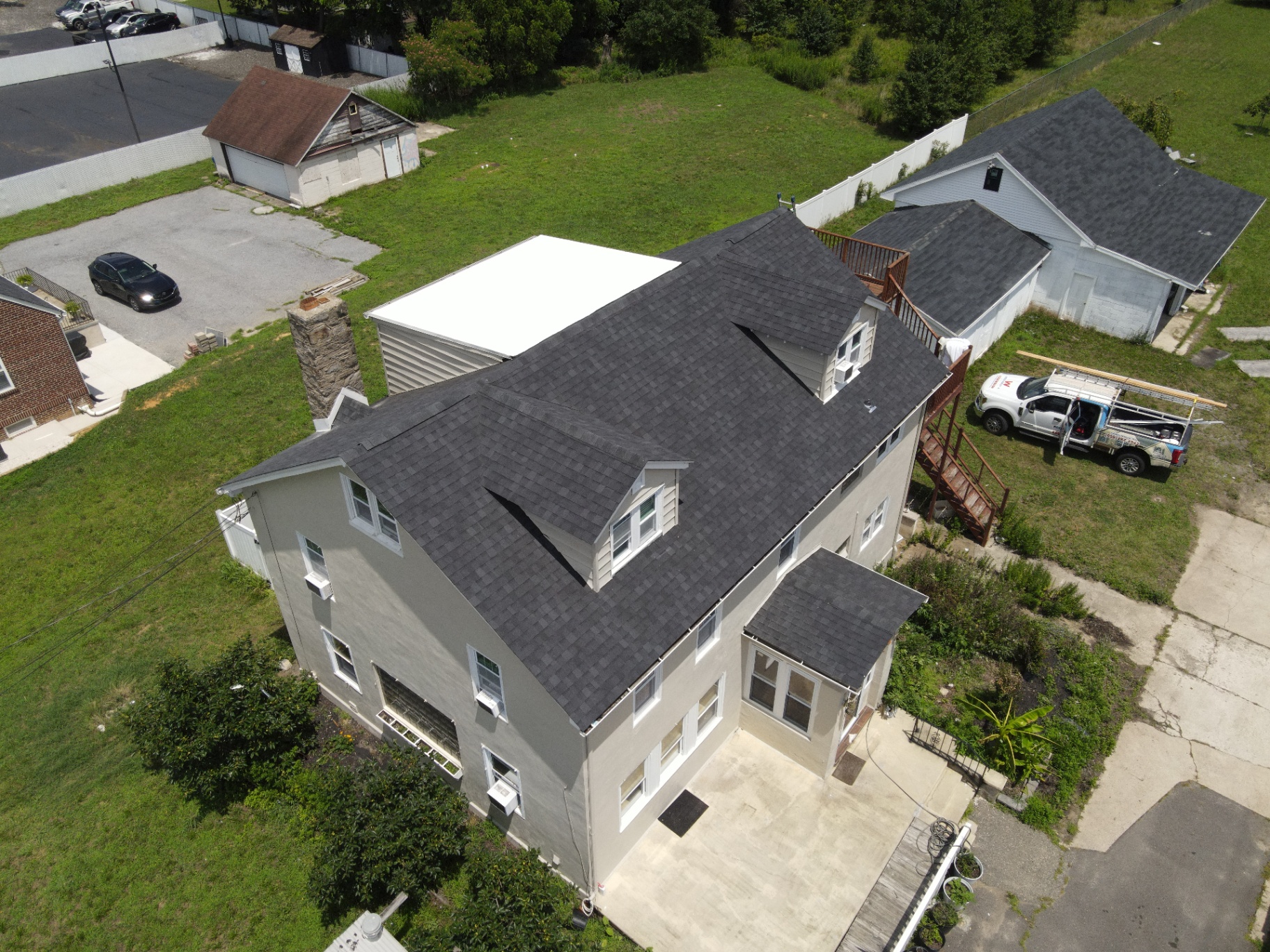 Completed charcoal residential roof on a multi-level home