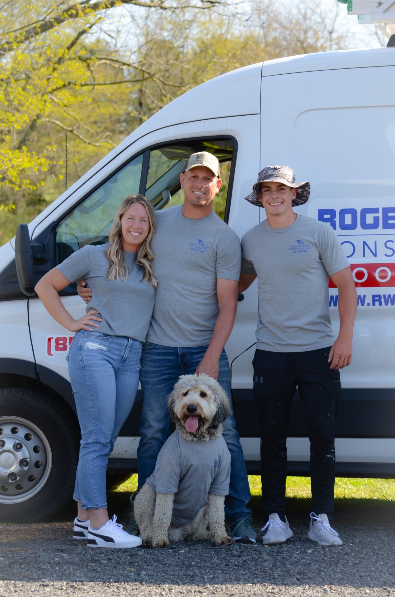 Roger Worley Jr. and family team standing in front of company van