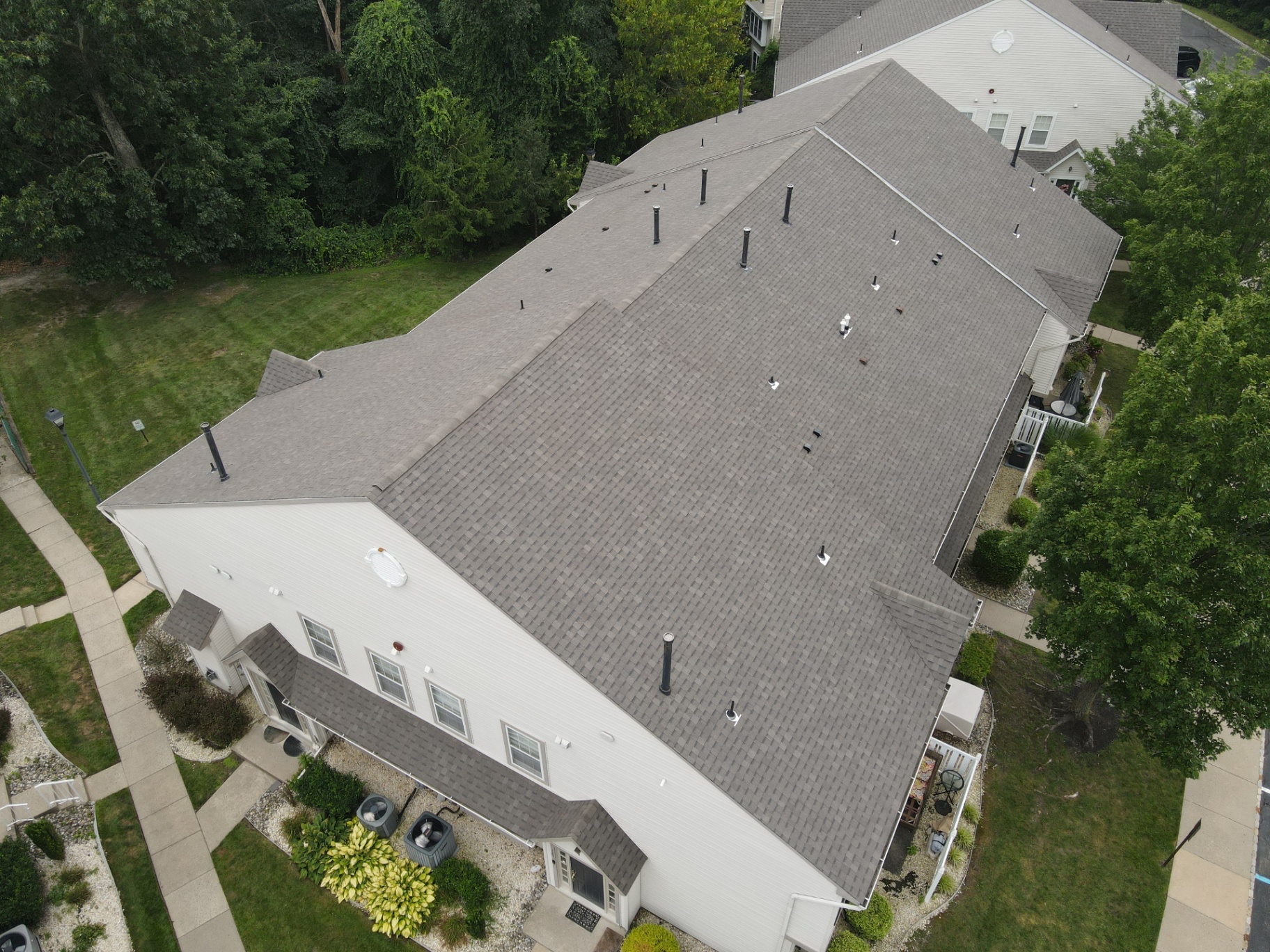 Large multi-unit residential roof completed with gray shingles