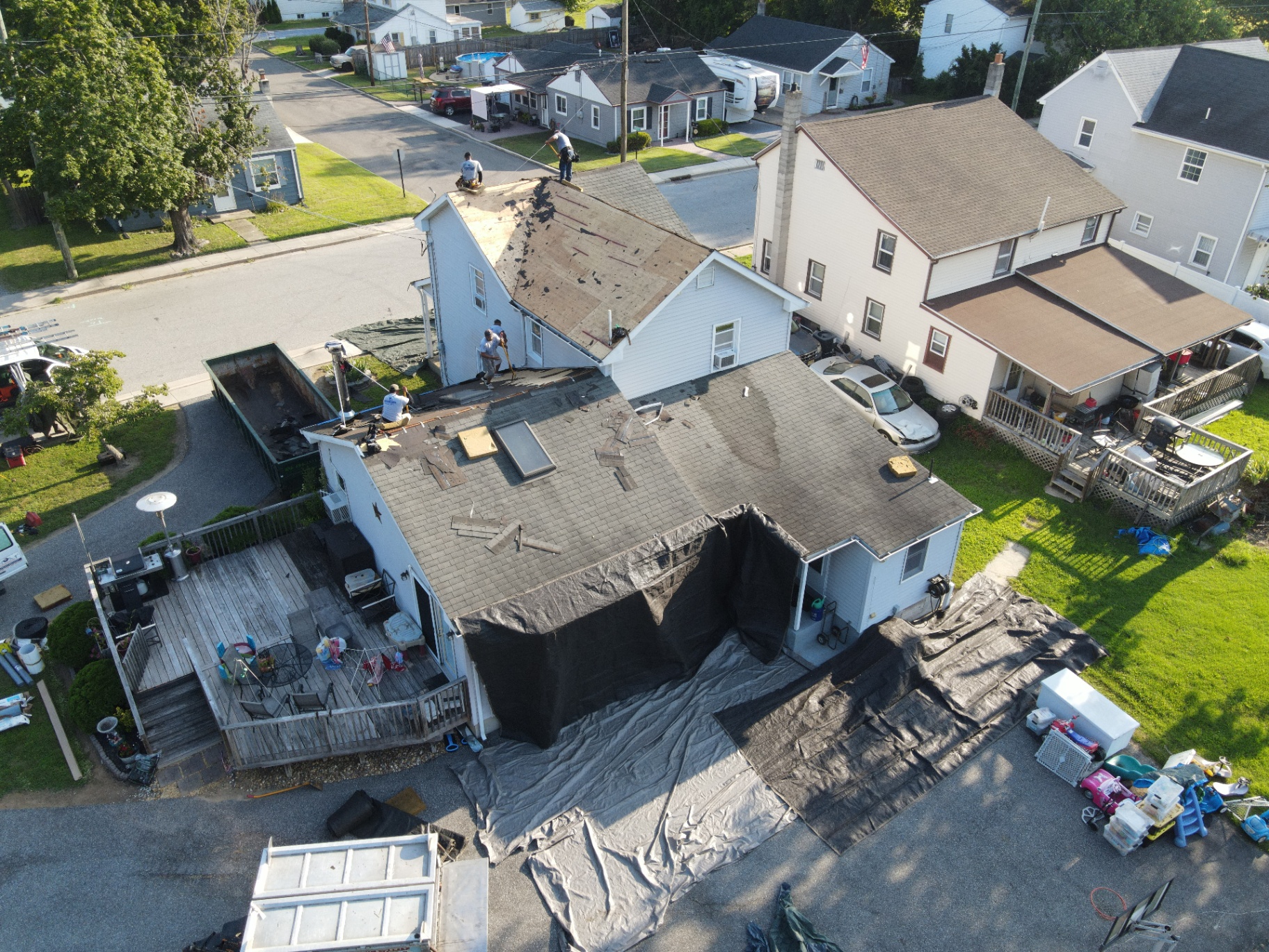 Aerial view of roof tear-off in progress on a residential home
