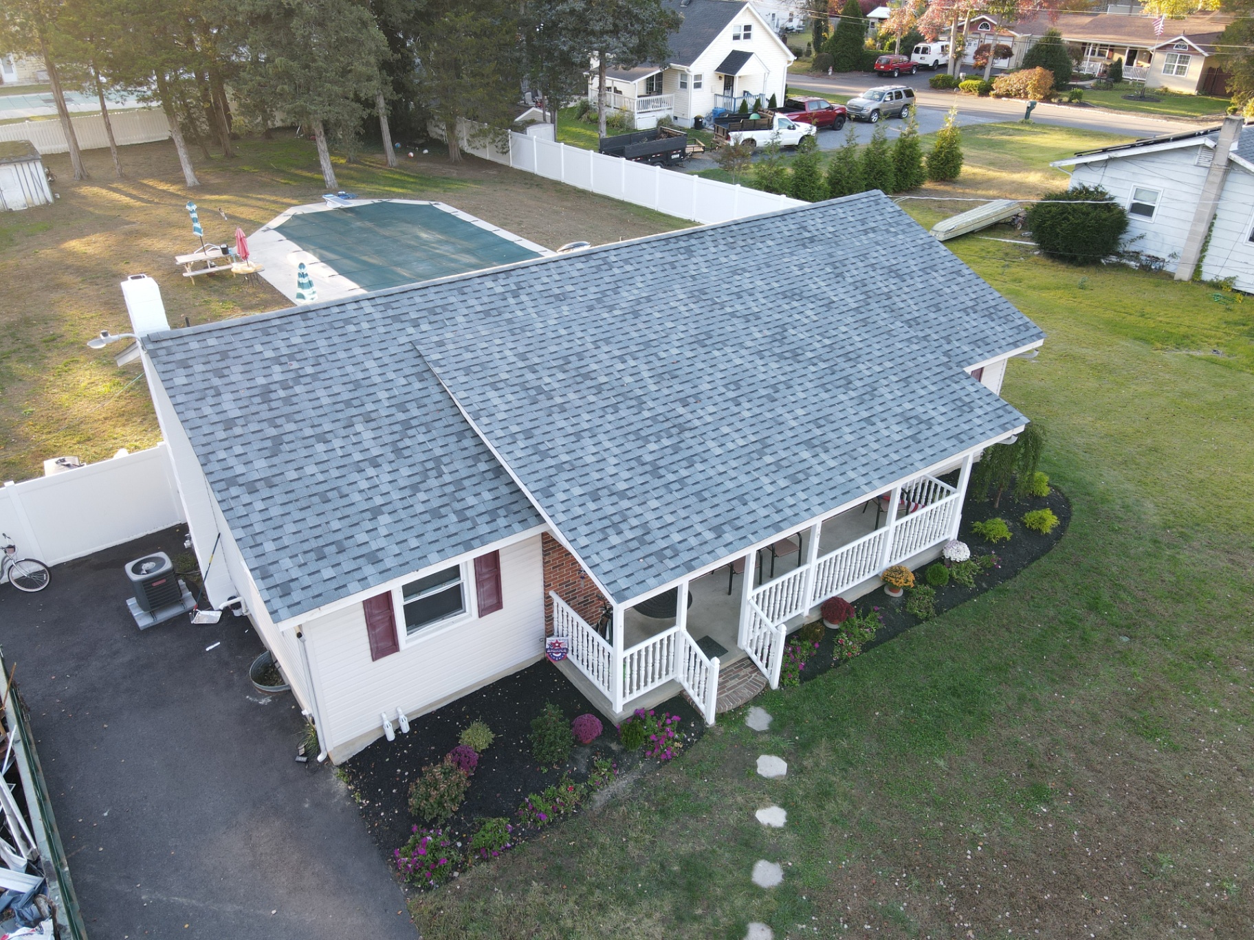 Completed residential roof on a ranch home with gray architectural shingles
