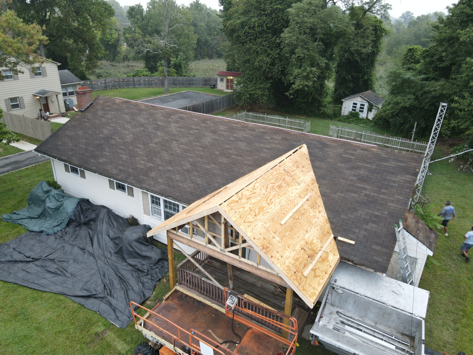 Aerial after photo of the same ranch home with a completed gray architectural shingle roof