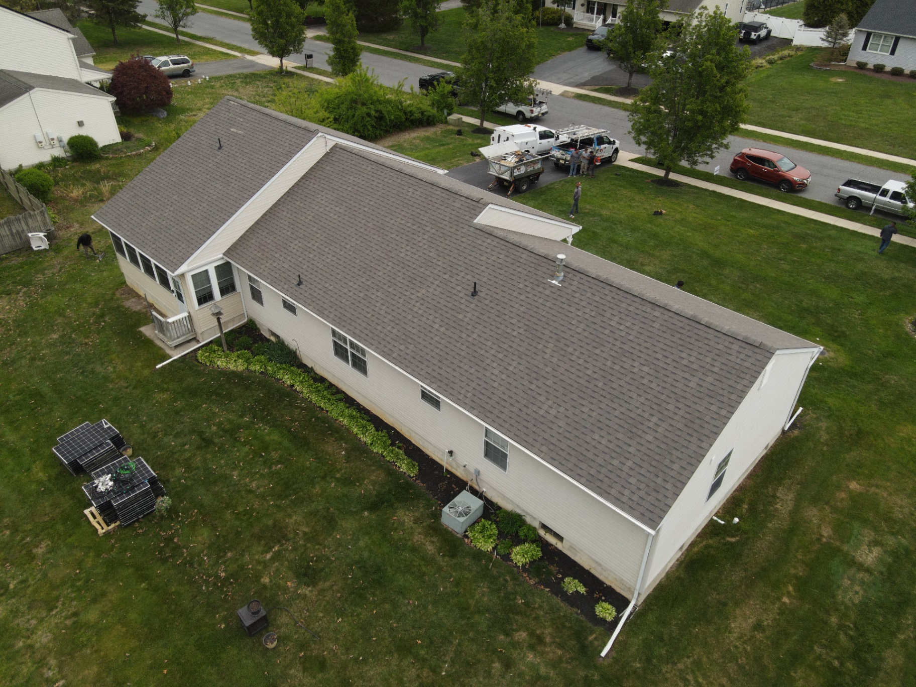 Completed brown architectural shingle roof on a long ranch home